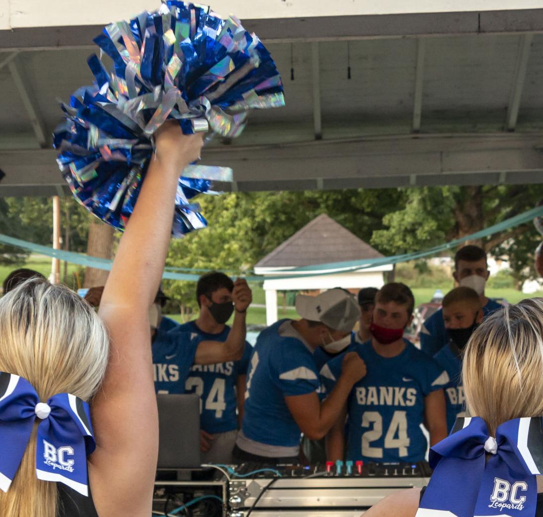 Gives cheer lesson to football team